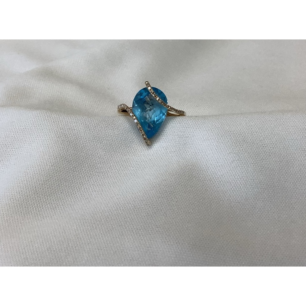 Blue topaz and diamond ring in 14 karat yellow gold.